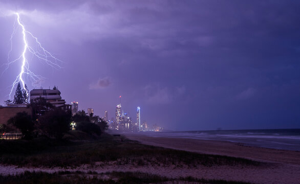 Lightning bolts across the night sky against the Gold Coast cityscape