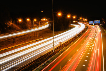 Fototapeta na wymiar Car lights at a highway at night