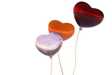 heart shaped balloons on golden string flaming red orange, pale pink bubble glass reflecting sunset on the beach - abstract 3D illustration - isolated  © Stylecore
