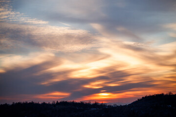 Fototapeta na wymiar Sunset in different colors on the sky, horizon