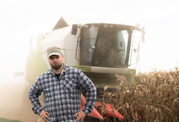 Young farmer examine corn seed in corn fields