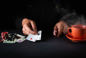 A professional player in a poker club shows the winning combination in one pair cards. Success or...