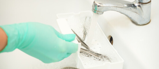 Hand in glove cleans the tweezers with water in-tray. Cleaning systems for tweezers