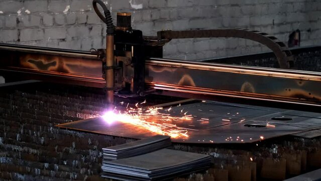 Plasma cutting of metal with a cnc. A plasma cutter cuts a workpiece from a sheet of metal. Laser cutter in production. Industrial metal cutting by plasma laser. 4K video. High definition video
