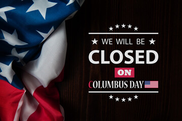 Columbus Day Background Design. American flag on a wooden table with a message. We will be Closed...