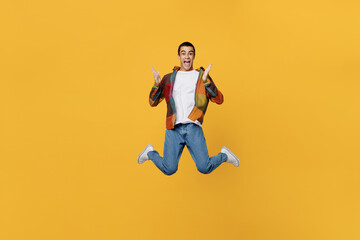 Full body young overjoyed excited surprised excited happy middle eastern man wear casual shirt white t-shirt jump high spread hands isolated on plain yellow background studio People lifestyle concept.