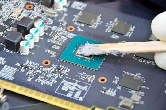 Image of technician filling silicone heat sink chip CPU