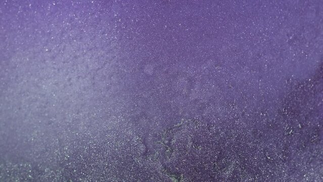 Vertical video. Glitter background. Fantasy mist. Bokeh light. Digital lavender purple color shimmering sparkles abstract grain texture. Shot on RED Cinema camera.