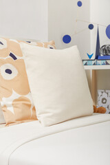 Decor pillow on the bed. Bedroom decorations. Bedding style. Scandinavian style. Interior and Home decor. Simplicity. Minimalist style. Beige colour pillow.