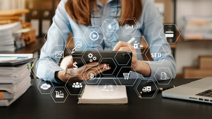 Designer woman using smart phone for mobile payments online shopping sitting on table,virtual icons .