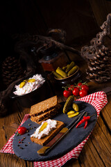 delicious spicy meat salad with cucumber on the black bread