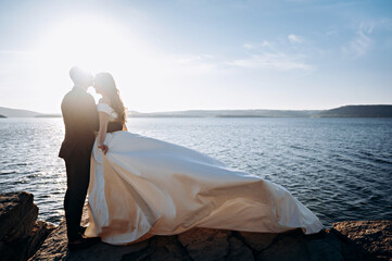 Beautiful wedding couple kissing on the background of sea