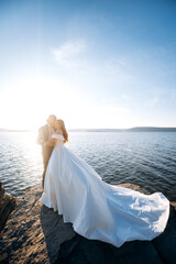 Beautiful young wedding couple at the shore