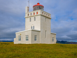 Fototapeta na wymiar Dyrhólaey Lightsthouse (Dyrhólaeyjarviti), a beautiful structure built in 1919, Southern Iceland