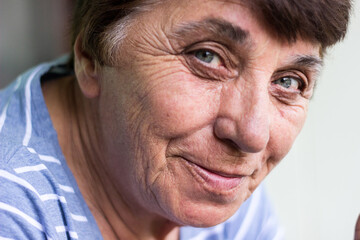 Happy senior woman with smile. Sitting at home