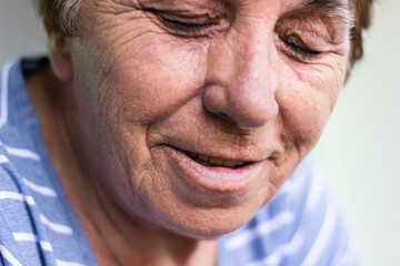 Happy senior woman with smile. Sitting at home