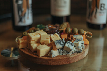 Cheese tasting on a wooden plate. Food for wine and romantic, cheesy delicacies. Cheese set.