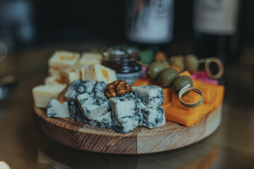 Cheese tasting on a wooden plate. Food for wine and romantic, cheesy delicacies. Cheese set.