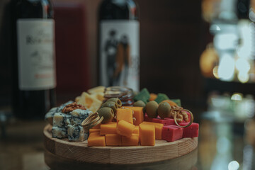 Cheese tasting on a wooden plate. Food for wine and romantic, cheesy delicacies. Cheese set.