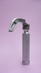 medical device for tracheal intubation - laryngoscope on a pink background. postcard for anesthesiologists