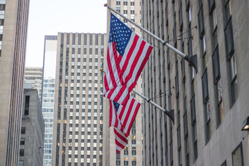 American flag waving in blue sky