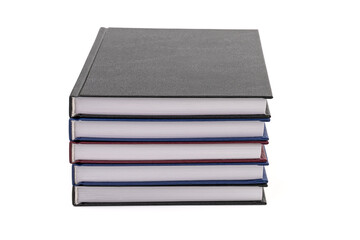 Stacked hardcover notebooks on white background. Education business concept.