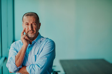 Portrait of modern senior businessman in suit with crossed arms