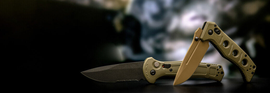 Khaki military pocket folding knives. Compact metal sharp knife with a folding blade. Blurred back.
