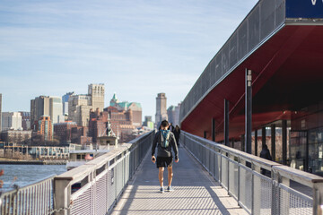 Athelte man running in New York City street wearing sport clothes Brooklyn Bridge