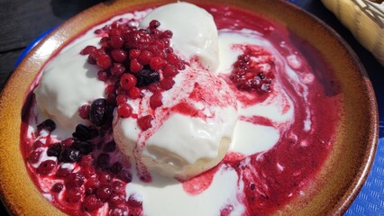 Steamed dumplings with fruits and cream sauce. Czech fruit dumplings