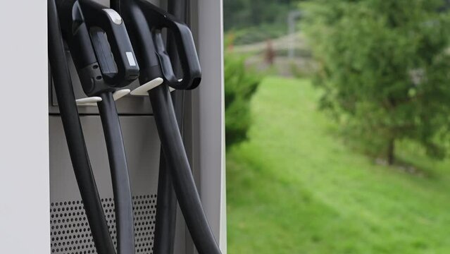 Public charging station with electric car charging ports. Ecology conservation concept, future technologies, electric vehicles, alternative energy. Slow motion