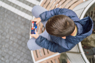 Stylish teenager using phone in city