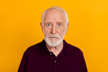 Photo of mature serious man intelligent wear causal clothes calm isolated over yellow color background