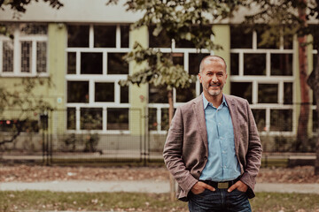 Focused businessman in a suit walking in the park