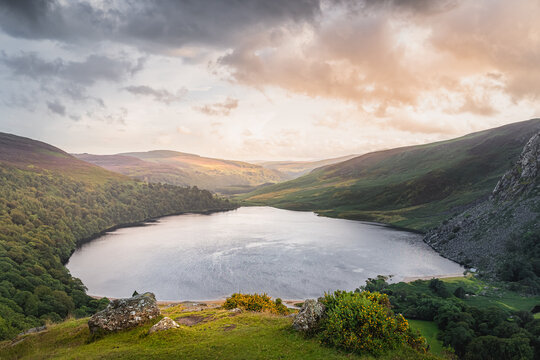 Beautiful and dramatic sunset at Lough Tay, called The Guinness Lake located in deep valley and surrounded by Wicklow Mountains, Ireland