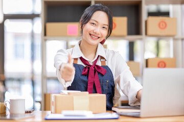 SME entrepreneur Small business entrepreneurs Online selling ideas,Happy Young Asian business owner work on computer and a boxs at home,delivery SME procurement package box deliver to customers,