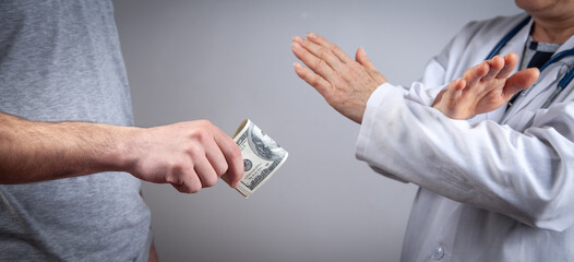 Doctor refusing a bribe. Corruption in medicine