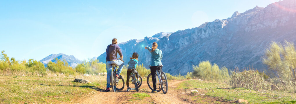 Rear view of family riding in mountain bike