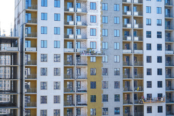 Fototapeta na wymiar Facade insulation work and insulation of a multi-storey building.