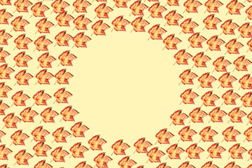 Creative pattren made of dried  leaves lying as a round frame on yellow pastel sunlit background. Autumn, fall, thanksgiving day concept. Flat lay, top view.