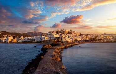 View from the Portara Gate towards the city of Naxos island, Cyclades, Greece, during a beautiful summer sunset - obrazy, fototapety, plakaty