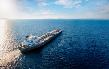Aerial view of a large, heavy loaded crude oil tanker traveling over open ocean