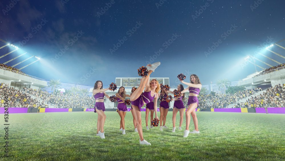 Wall mural group of cheerleaders in action on stadium in night