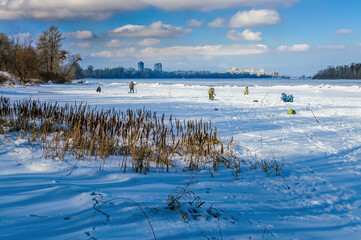 Fishermen on the frozen Dnieper in the Obolon district of Kiev, Ukraine, during a cold winter. In...