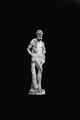 Fototapeta na wymiar Ancient destroyed stone statue of Hercules against as symbol of power and strength. Black and white image.