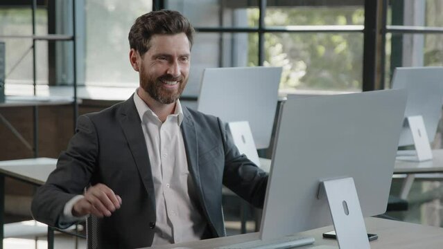 Caucasian bearded man boss leader worker manager businessman finish online project startup work day off with computer in office relaxes smiling satisfied leans back on chair holding hands behind head