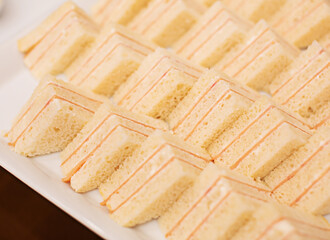 Several bread sandwiches on a white tray, close-up photo