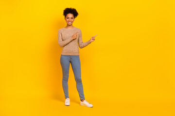 Full body photo of young cheerful girl indicate fingers empty space proposition suggest direct isolated over yellow color background