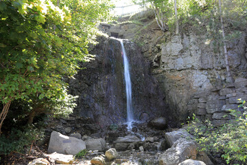 The Waterfall Area in downtown Petoskey, Michigan at Bayfront Park has a man-made waterfall, with the water running into Lake Michigan.