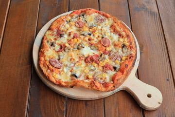 pizza is a dish of Italian origin consisting of a usually round, flat base of leavened wheat-based dough topped with tomatoes, cheese, and often various other ingredients, which is then baked at a hig